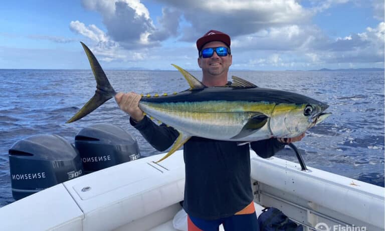 Book a fishing charter from Drift and choose from 8 different charters. Here a happy vistor showcases a 3 foot long yellowfin tuna that he's caught during his St. Thomas vacation.